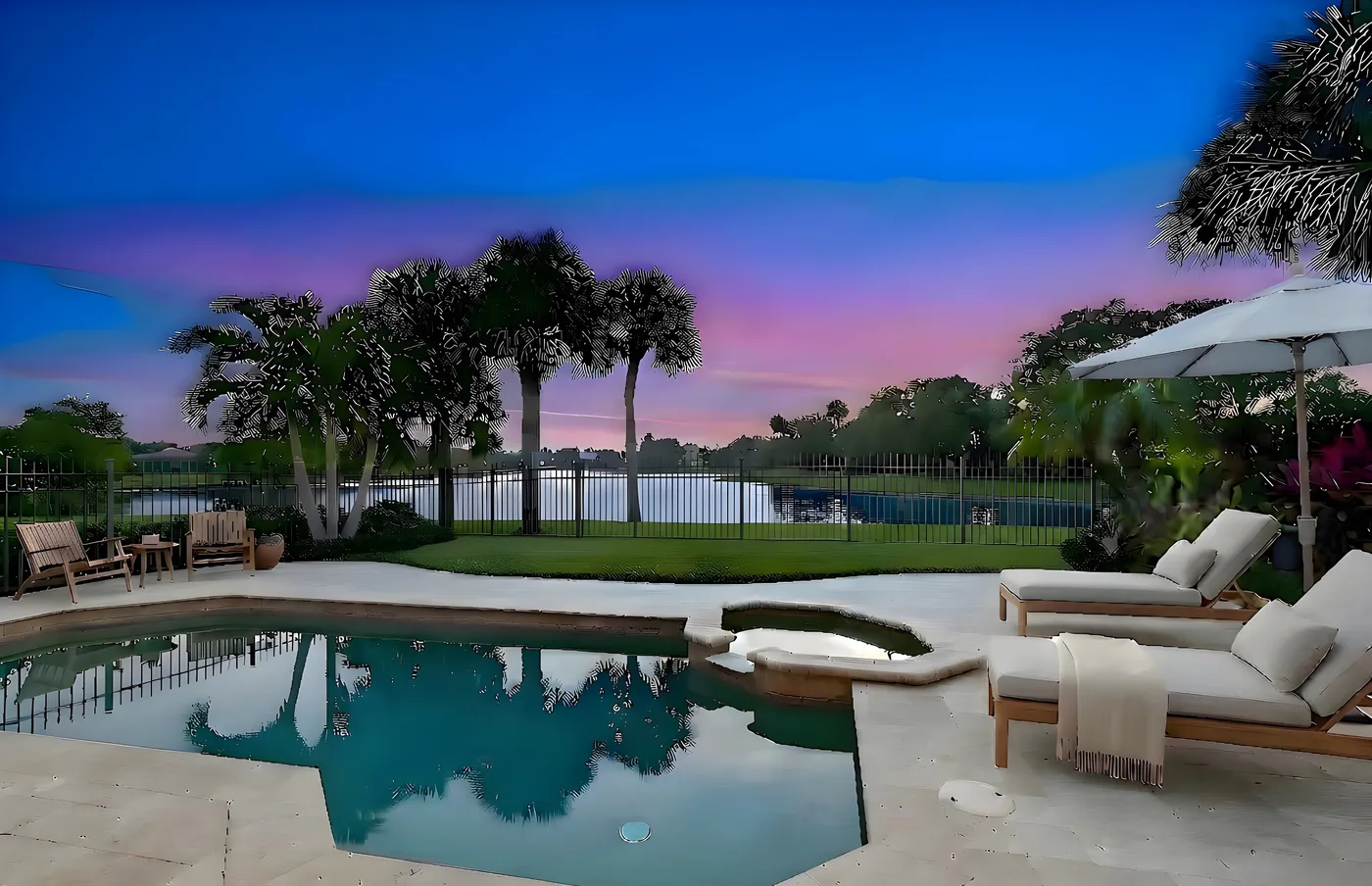 1710 Lake Club Court: the pool and the lake beyond at twilight