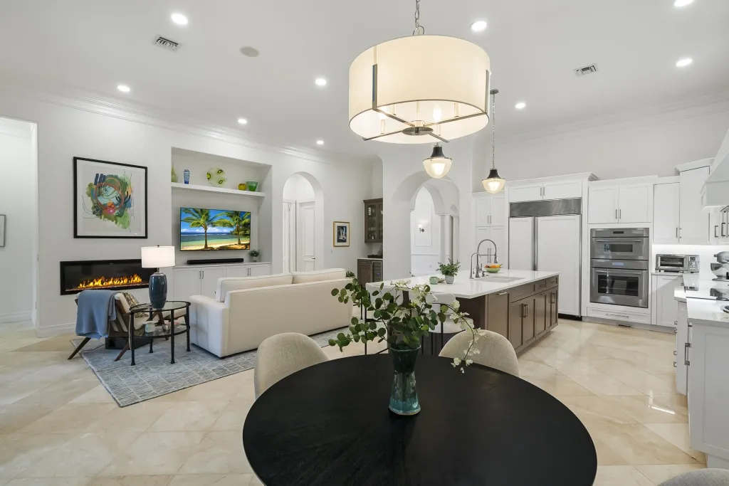 1710 Lake Club Court: the great room, with the fireplace and the kitchen beyond