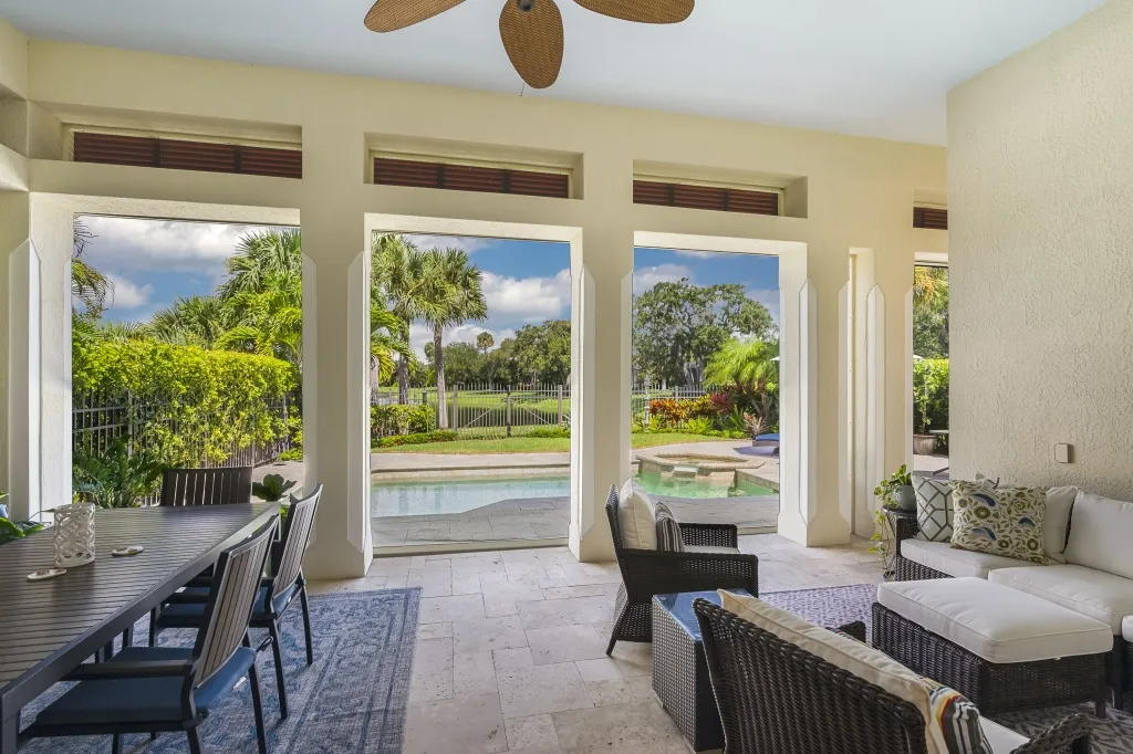 1710 Lake Club Court: the covered lanai and outdoor dining, facing the pool