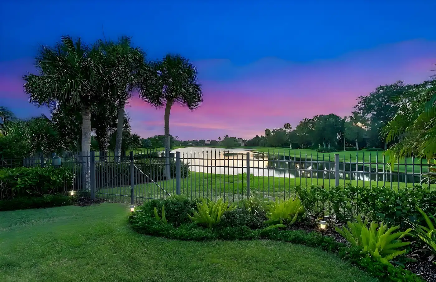 1710 Lake Club Court: the lawn and the lake at twilight