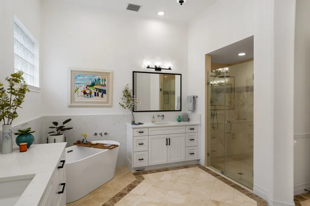 1710 Lake Club Court: a guest bathroom with the tub and walk-in shower