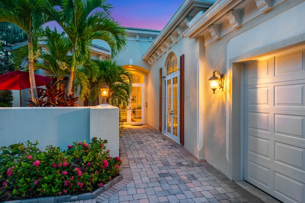 1710 Lake Club Court: the entry courtyard at twilight