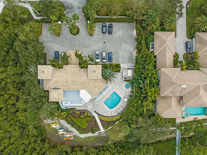 1710 Lake Club Court: an aerial over the riverfront clubhouse, with the kayak storage at the water
