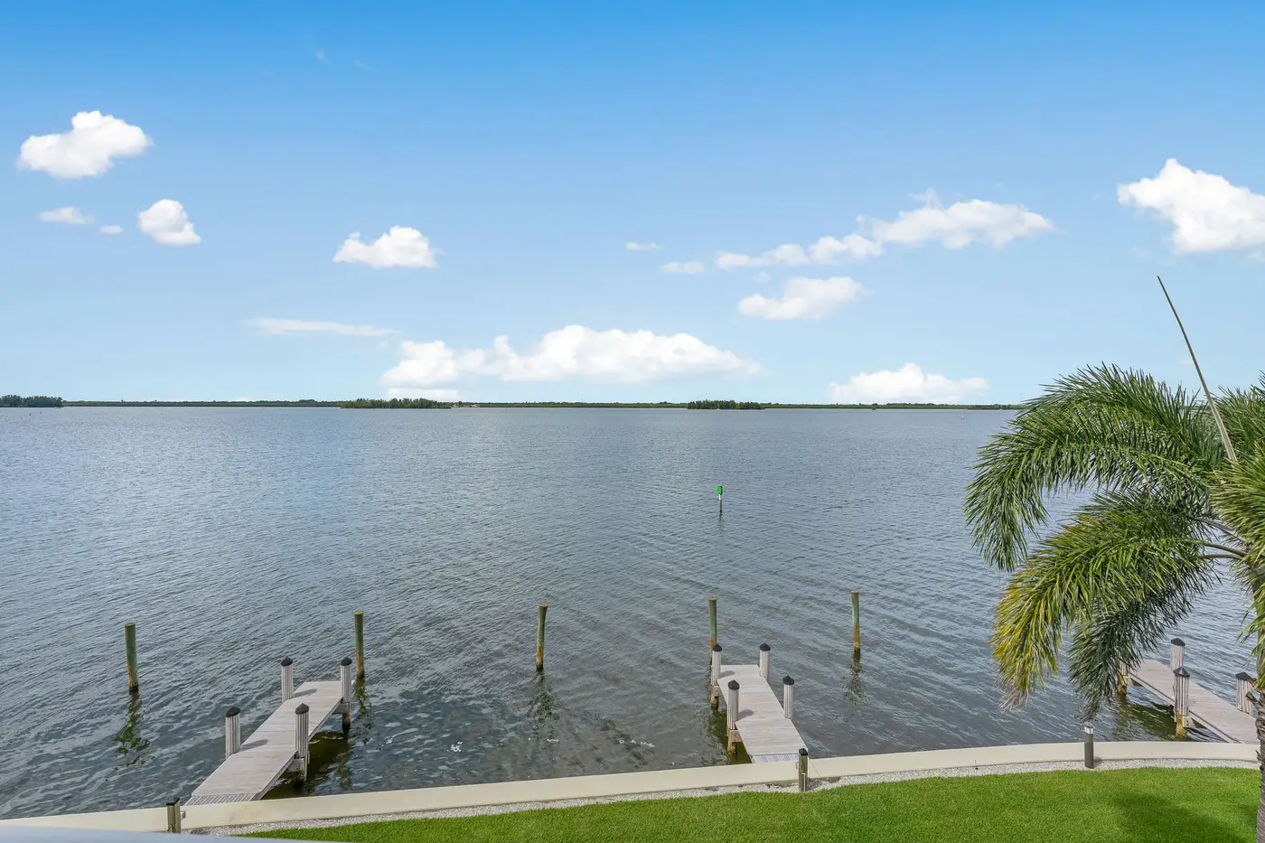 1776 Mooringline Drive, PH-C: wide open water and the private dock seen from the lawn