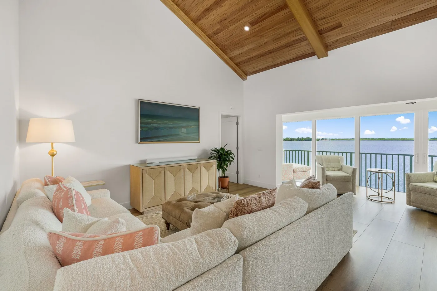 1776 Mooringline Drive, PH-C: the great room with the sloped cypress ceiling and the water beyond