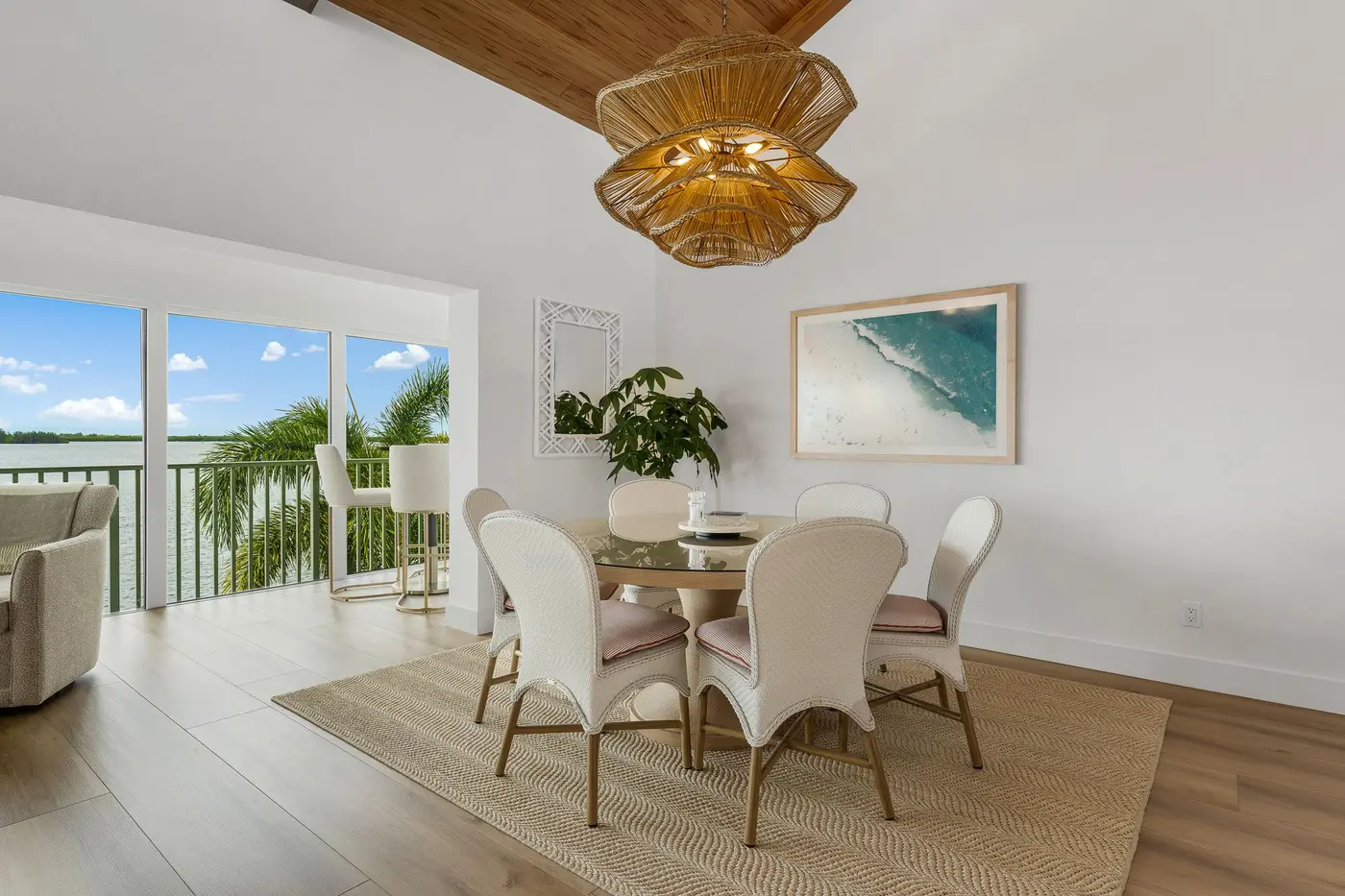 1776 Mooringline Drive, PH-C: the dining area with the water visible through the sliders